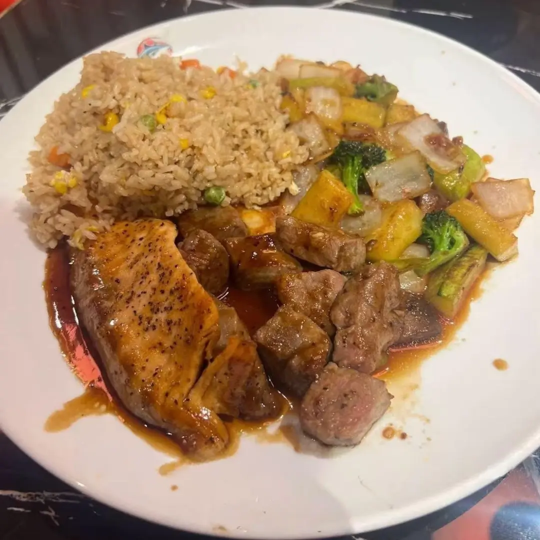 Rice, veggies, steak and salmon on a plate at AKAMI Sushi & Grill,a Japanese Restaurant in Dawsonville